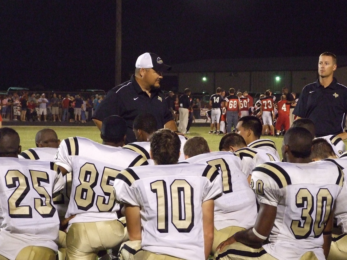 Image: Be strong, men — Head Coach Craig Bales gives the players a little positive reinforcement after their tough season opening loss to Maypearl, 23-19.