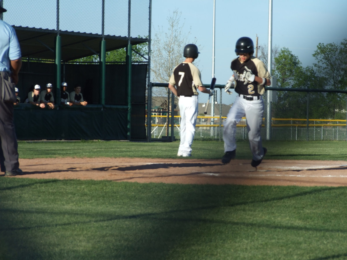 Image: Caden comes home — Caden Jacinto scores another as his team watches from the dugout.