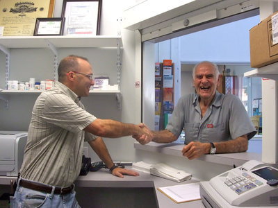 Image: Greeting the Customer — The new pharmacist greeting his new customer, Lou Martina.