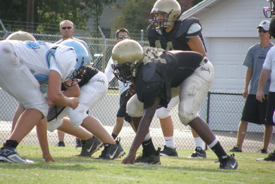 Image: Defending the Gold — Italy JV Gladiators dig in against the Cougars.