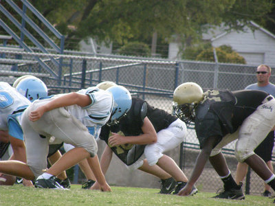 Image: Taking a stance — Larry Mayberry dares the Cougar defense to cross the line of scrimmage.