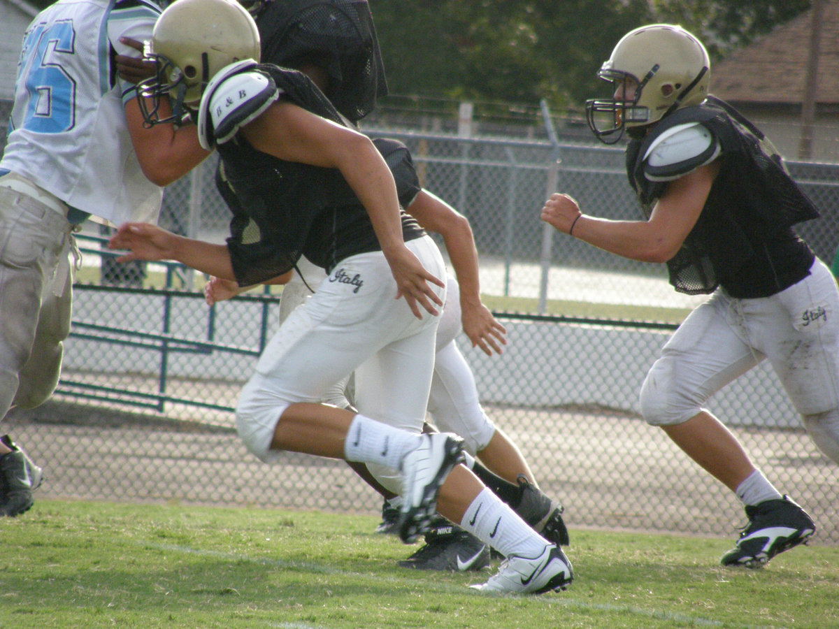 Image: Firing off — Italy’s defense runs buckshot through the Cougars.