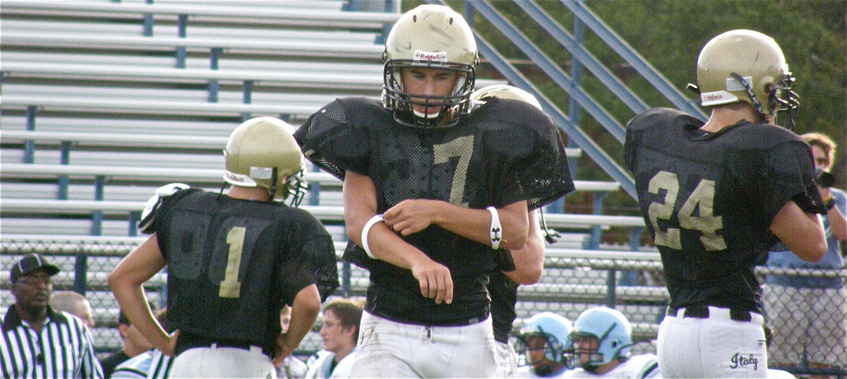 Image: Defense breaks huddle — Kyle, Tony and Chase get set on defense.