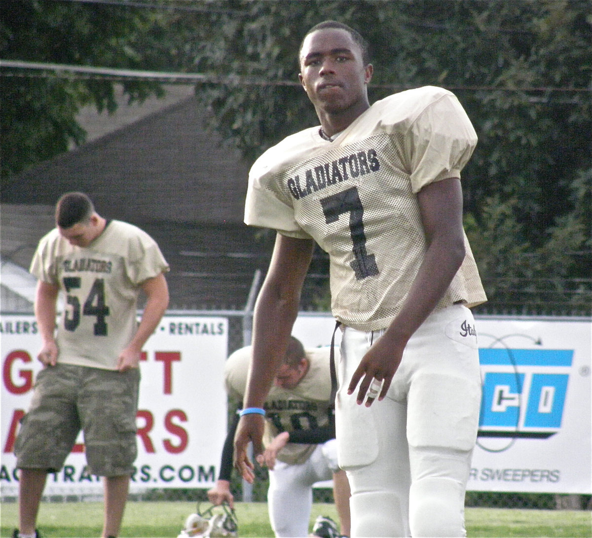 Image: Passing the time — Jasenio Anderson, starting quarterback for the Italy Gladiators gets loose before facing the Cougar defense.