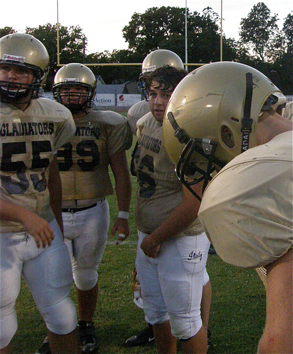 Image: Up front and personal — In the huddle with the “Bigs” who do the dirty work on the front lines of the Gladiator attack.