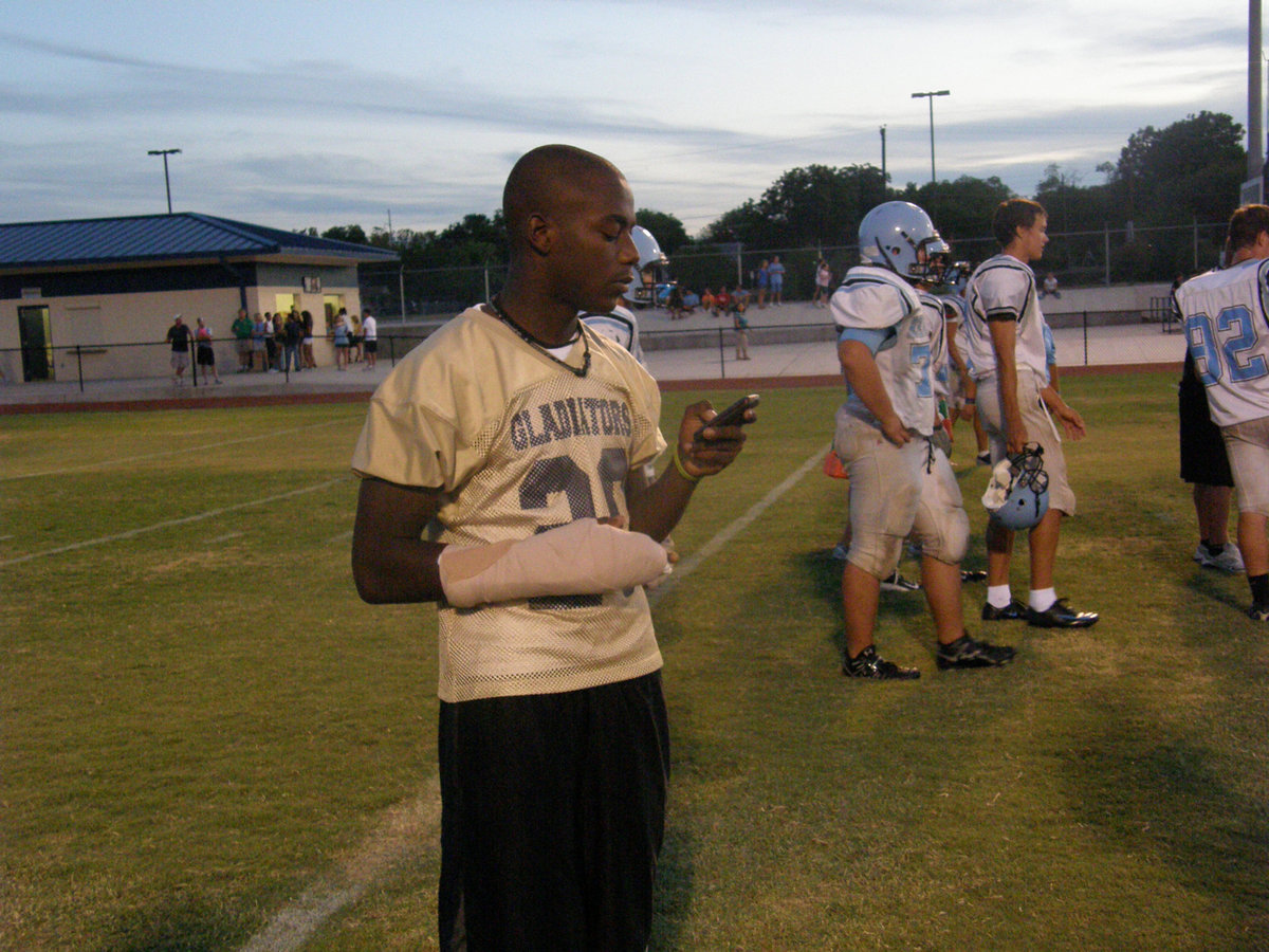 Image: Desmond gets dinged — Can’t break the Gladiator Spirit. Even with a break in his hand, Senior, Desmond Anderson, desperately wants to play against Maypearl.