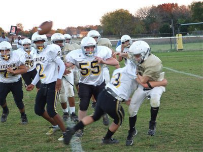 Image: Guts and glory — 7th grader J.T. Escamilla showed guts as he stood in the pocket, until the last second, to deliver the pass to [Name Withheld] who ran 82-yards for the touchdown. Unfortunately, a clipping penalty nulified the exciting play.