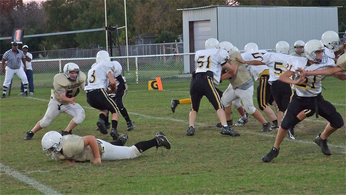 Image: Catching a cat — Kevin Roldan dives into the Itasca backfield as John Byers closes in on the quarterback.