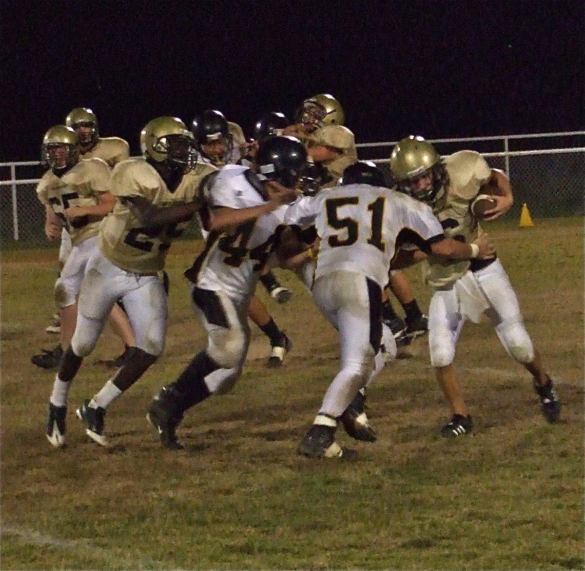 Image: Teamwork — Jake Escamilla(65), Corrin Frazier(25) and Ethan Saxon(44) lead block for Tony Wooldridge(6) against Itasca.