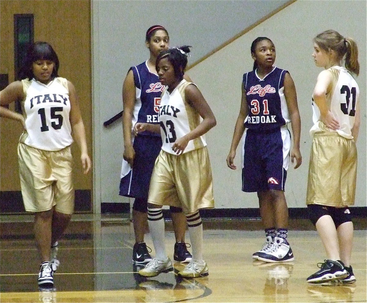 Image: Playing tough — Ashley Harper(15), Kendra Copeland(13) and Taylor Turner(31) try to catch their breath in an effort to keep pace with the Lady Mustangs of Red Oak Life.