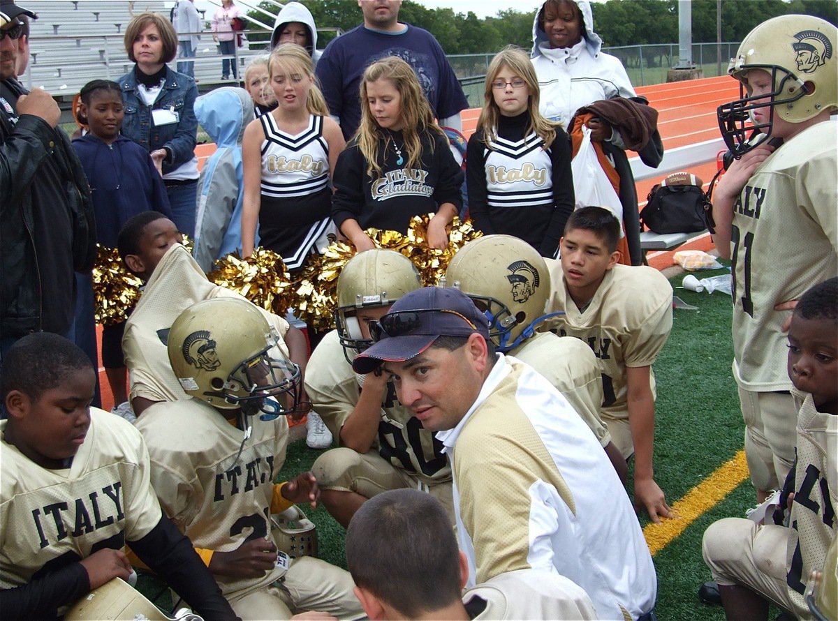 Image: You guys were great! — Proud Parents, cheerleaders and coaches huddle around the A-Team in a show of support after their big win over Ferris, 20-6.