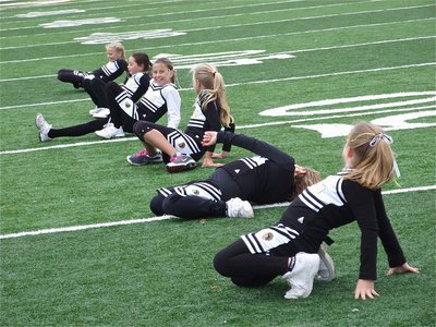 Image: Did I do this right? — C-Team Cheerleaders perform during halftime and show off their mad skills…