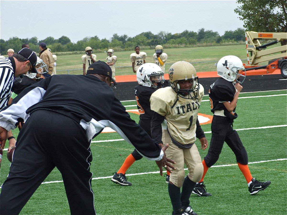 Image: Good job, Son! — Coach Ken Norwood gives his son, Kendrick Norwood, a low five for a job well done after Kendrick caught a pass and carried close to the Ferris five.