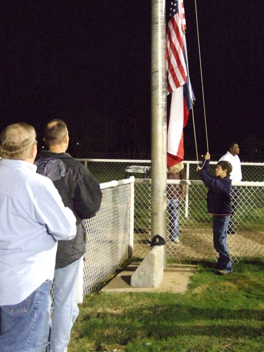 Image: Veterans honored — Local veterans, Earl Goodwin and Paul Cockerham, were honored with a flag raising ceremony before the game.  Goodwin served from 1968-1971  in South Vietnam and leaving the Army in 1976. Cockerham served in the Navy 1989-1991.  Italy ISD appreciates the sacrifice these men offered to protect our nation and community.