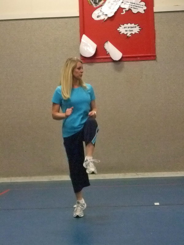 Image: Angie Janek — Mrs. Janek (PE teacher) is teaching the moves to the dance.
