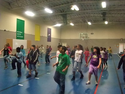 Image: Lift Those Legs — The students are really getting into the swing of the line dances.