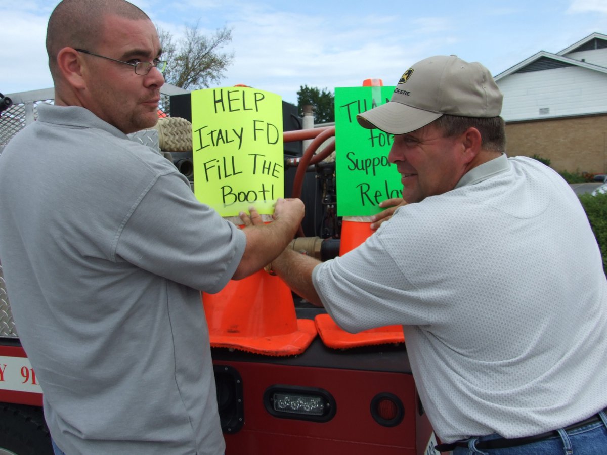 Image: Chambers and Mathiowetz prepare — Brad Chambers and Brian Mathiowetz prepare for the “Fill the Boot” fundraiser.