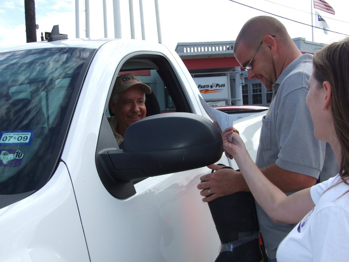 Image: Graves, Chambers and Svehlak — Macky Graves stops to give a donation to Brad Chambers and Kelly Svehlak.