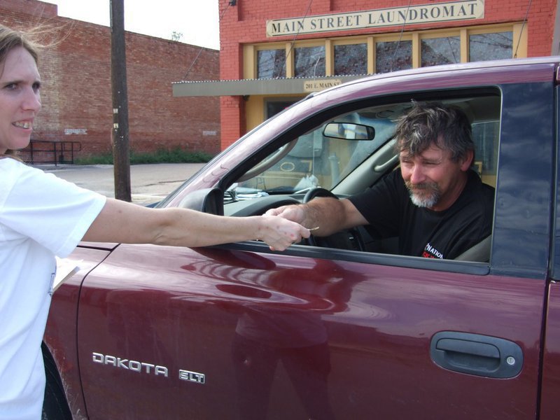 Image: Jerry Huffman gives donation — Jerry Huffman stops to donate. “Fill the Boot” volunteer Kelly Svehlak is there to accept it.