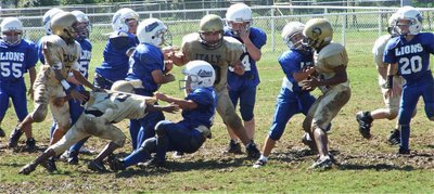 Image: Big hit! — This Blooming Grove runner receives a rude welcome from James McIntyre(10) and the B-team defense.