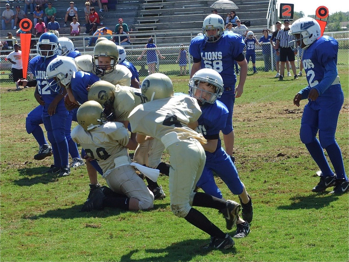 Image: The defense arrives — The IYAA B-team defense posted a shutout against the Lions in a 26-0 win.