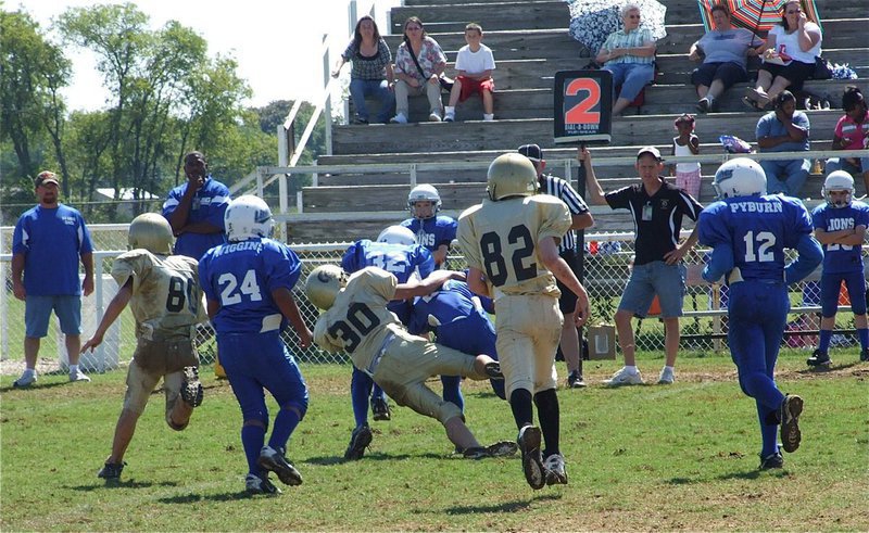 Image: When Gladiators attack — The IYAA Gladiators A-team defense led by Joseph Celis(30) stalk the Lions from behind.