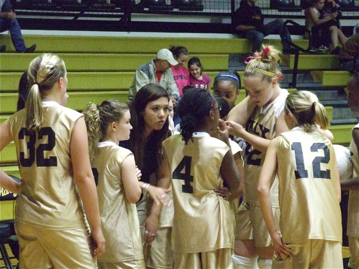 Image: Play your game — Coach Tina Richards huddles with the 7th graders.