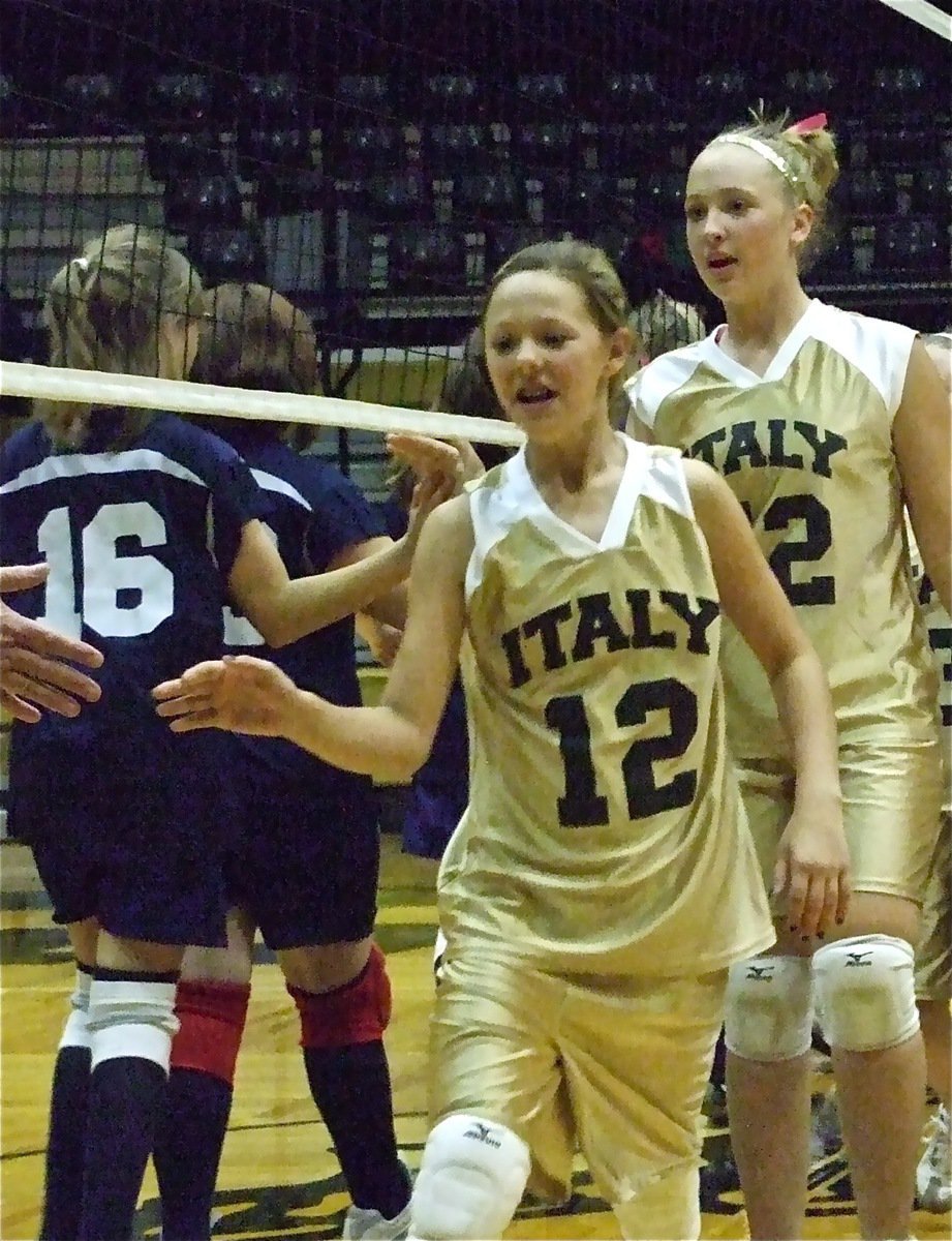 Image: 7th grade goes 6-0 — Bailey and Jaclynn congratulate the other side knowing their side has just pulled off the perfect season.