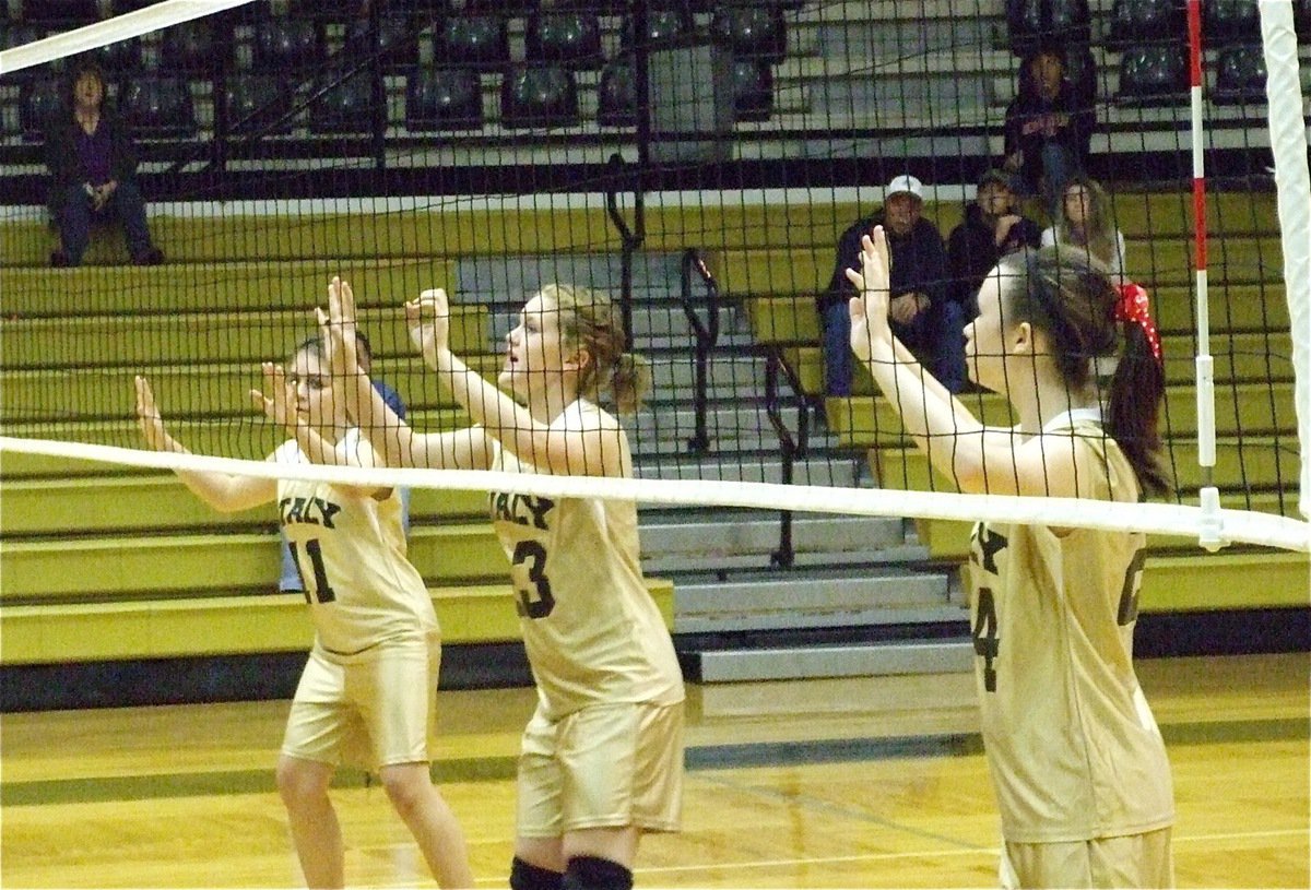 Image: The front line — Taylor Patterson, Jesica Wilkins and Meagan Hooker get ready to return the volleyball.