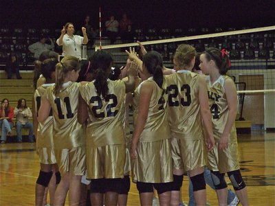Image: 8th grade huddles — Coach Andrea Windham tries to rally the team.