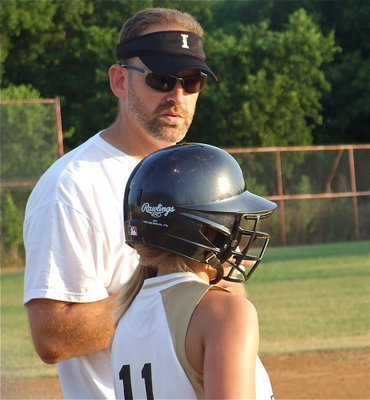 Image: Coach advises — Coach Doug Nelson gives advice to Mary Tate before she goes up to bat.