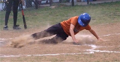 Image: Count it! — Brandon Connor slides across the plate against Itasca in game two.
