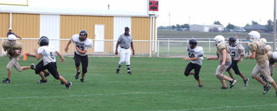 Image: Colton is bolting — Colton Petry (6) tries to turn the corner against the Tiger defense.