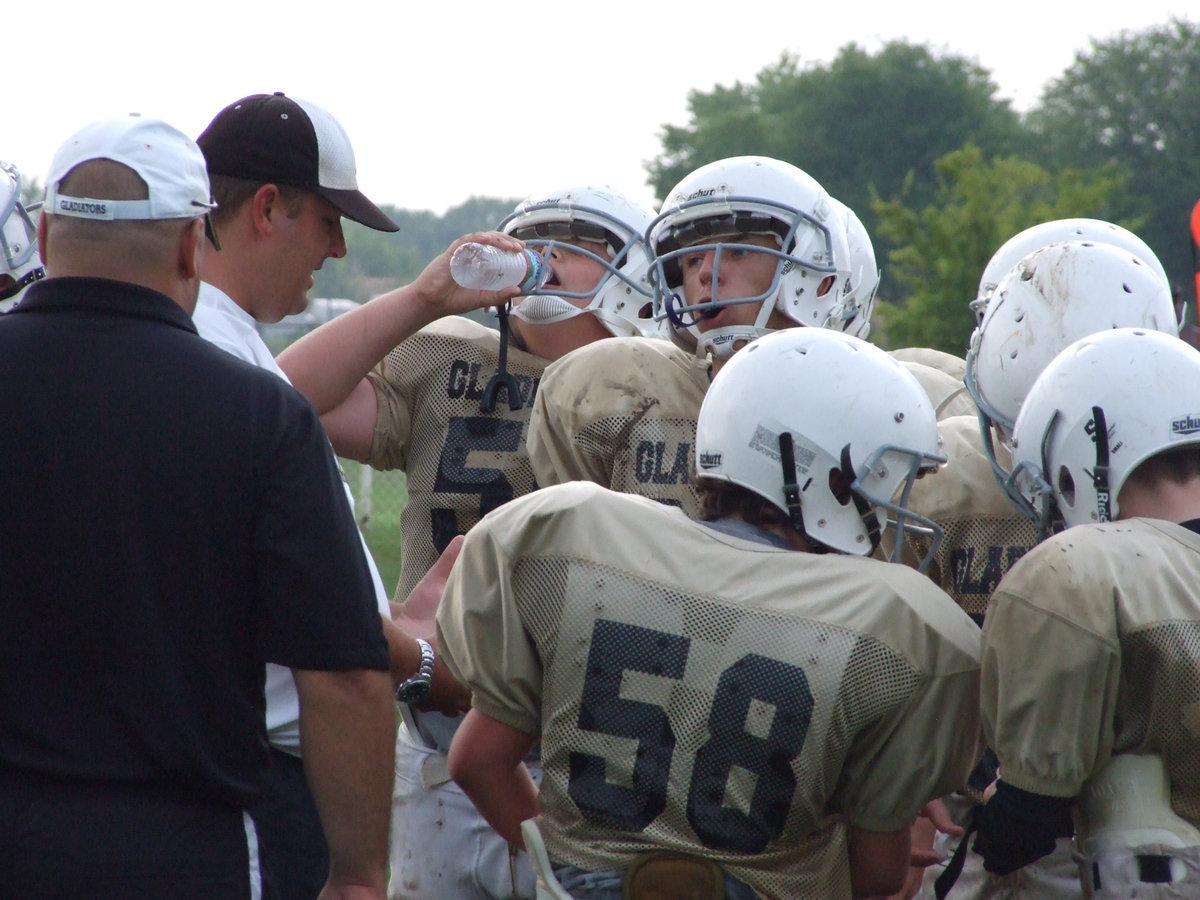 Image: 11 strong — Coach Matt Coker huddles with his 7th Graders against Malakoff.