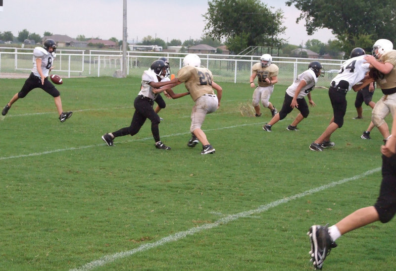 Image: Pressuring the punt — Italy’s 8th Grade defense forces Malakoff to punt it away as Cody Medrano (28) applies pressure.