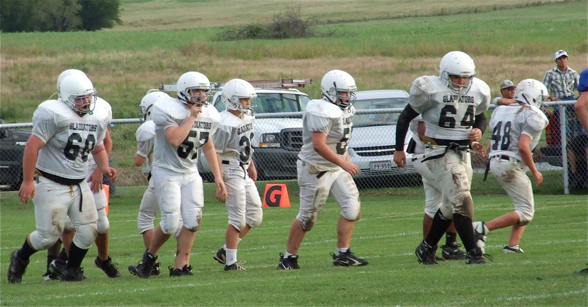 Image: Offense breaks huddle — Italy muds it’s way to the line of scrimmage.