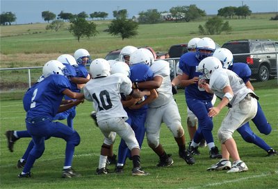 Image: Two tough — Eric Carson(10) and Darol Mayberry(56) converge on a Frost ball carrier.