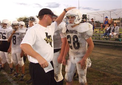 Image: Nice job — Coach Ward gives Cody Medrano(28) praise for a well played game.