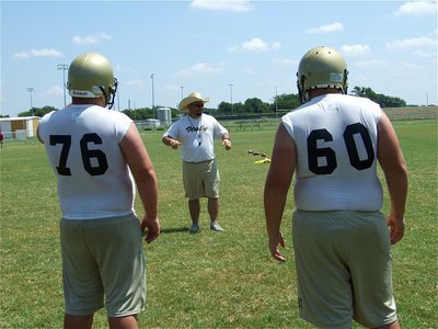 Image: We love lineman — Coach Craig Bales spends some time with the J.V. crew.