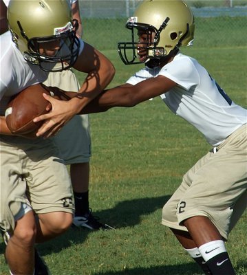 Image: Attention to detail — Eric Carson(12) works on executing proper handoffs with Chase Hamilton(24).