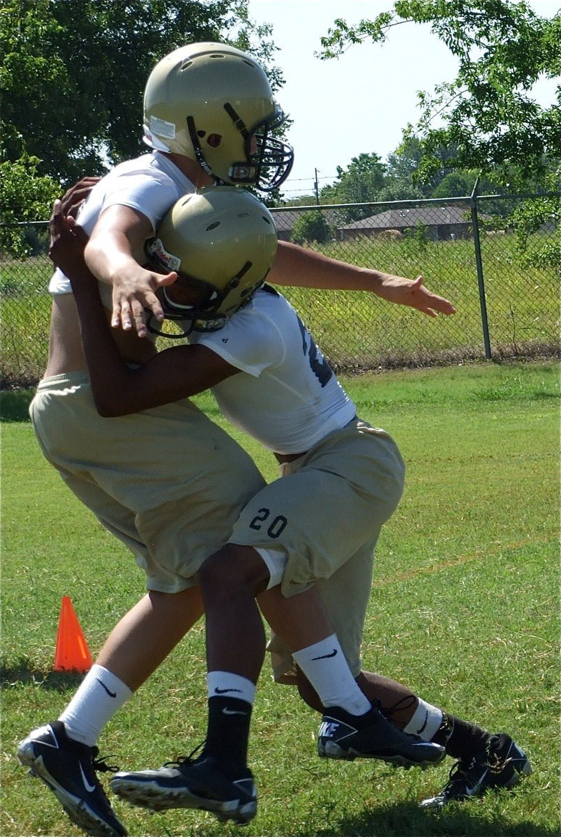 Image: One step at a time — De’Andre Sephus(20) form tackles Kyle Jackson.