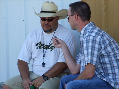 Image: When Coach talks… — Chad Wilson, a sports editor for the Waxahachie Daily Light, interviews head football coach Craig Bales of the Italy Gladiators.