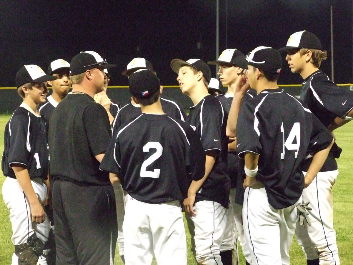 Image: Coach Ward and the gang — The Gladiator JV team rallies around Coach Ward after the game.