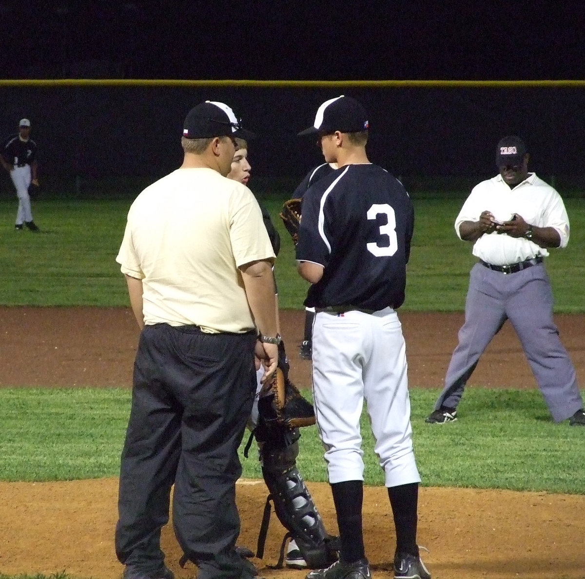 Image: Let’s talk about it — Coach Coker, Ross Stiles and Jase Holden line up the next play.