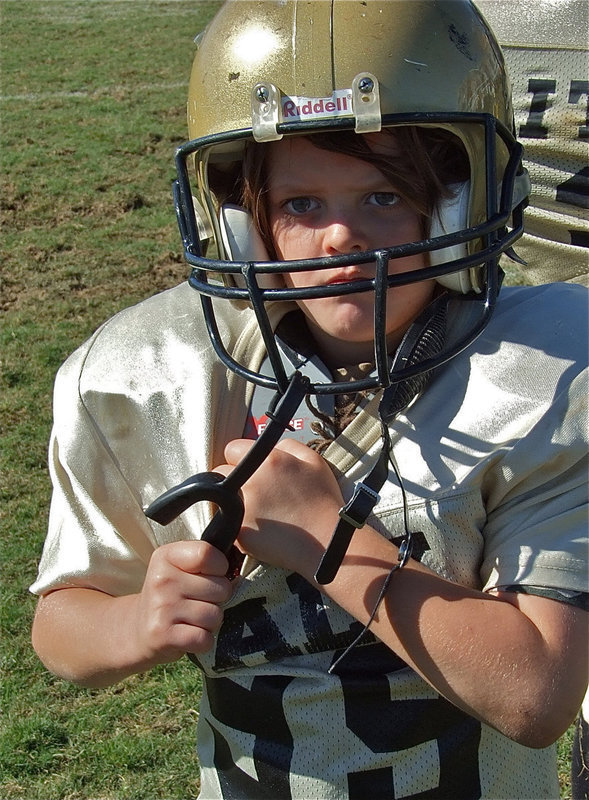 Image: Cason Roberts — Cason listens to the coaches while removing his pads after their 33-0 win over Hubbard.