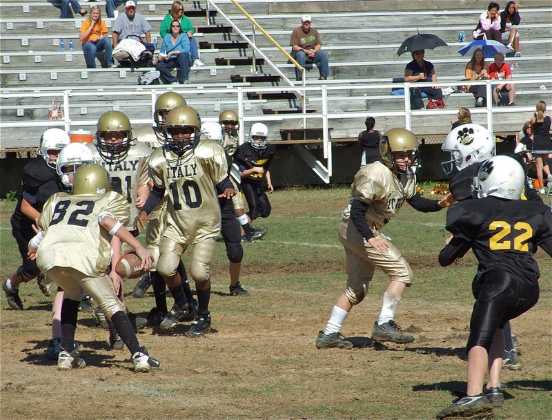 Image: On the move — A-team quarterback, Austin Maynard, decides not to pass and looks for running room.