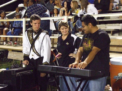 Image: Mr. Perez boogies — Ronald Helms and principal Tanya Parker watch Mr. Perez during half time.