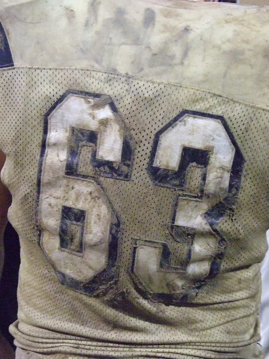 Image: A whole lotta mud — Zach Hernandez is having some good clean fun as he carries some of Willis field on his back.