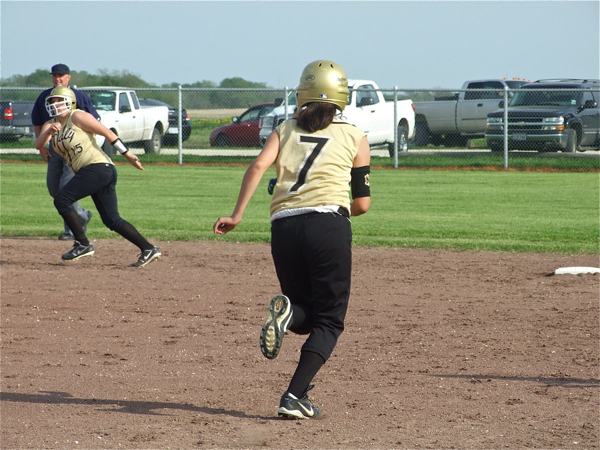 Image: Running away with it — Alma Suaste(7) heads to second and Cori Jeffords hurries to third after another Lady Gladiator hit.