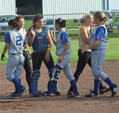 Image: Show of respect — Bailey Bumpus, Alyssa Richards and Megan Richards show good sportsmanship after the game.
